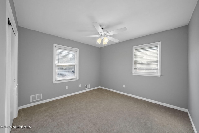 carpeted empty room featuring ceiling fan