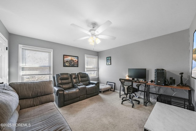 office space with light carpet, a wealth of natural light, and ceiling fan