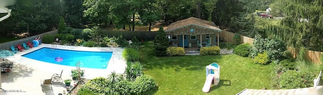 view of pool with a yard and an outdoor structure