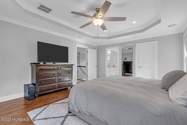 bedroom featuring ceiling fan, ornamental molding, and a tray ceiling