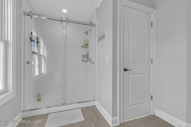 bathroom featuring a shower with door