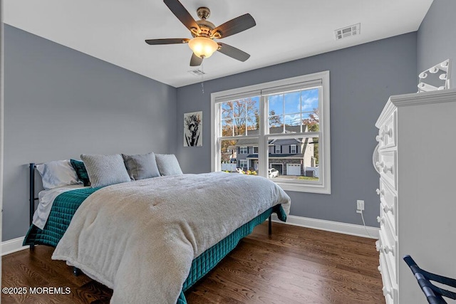 bedroom with ceiling fan and dark wood-type flooring