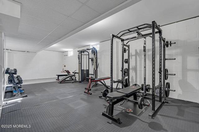 workout room with a paneled ceiling