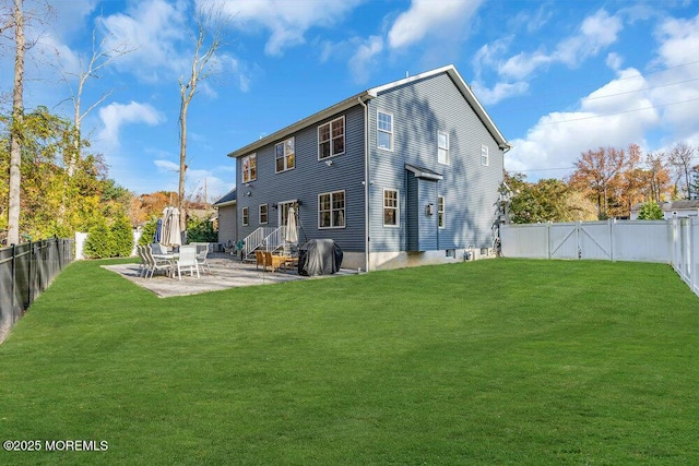 rear view of house with a patio and a lawn