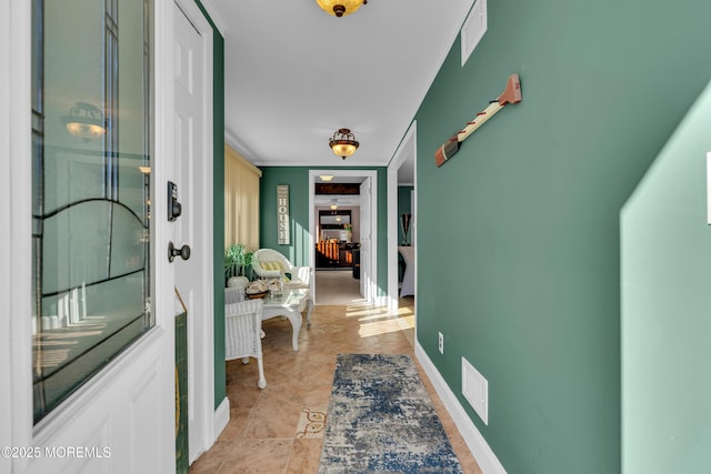 hallway with light tile patterned floors and built in features