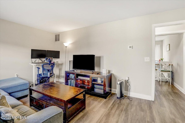 living room with light hardwood / wood-style flooring