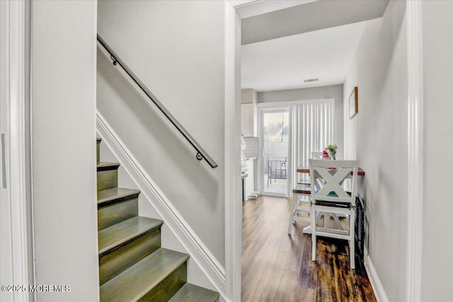 stairway featuring hardwood / wood-style flooring