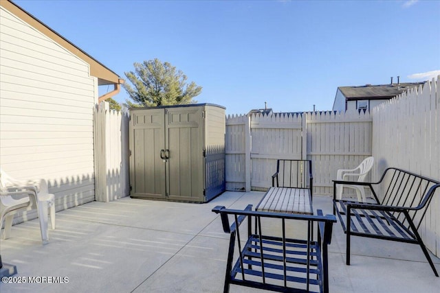 view of patio featuring a storage shed