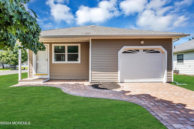 single story home featuring a front lawn and a garage