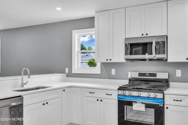 kitchen featuring sink, white cabinets, and stainless steel appliances