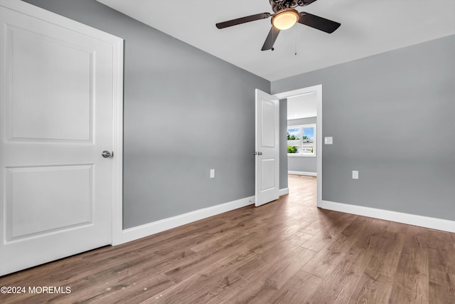 unfurnished bedroom featuring ceiling fan and hardwood / wood-style floors