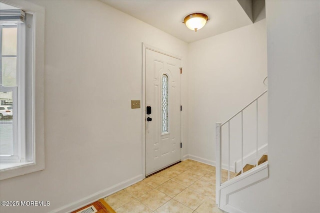 foyer entrance with light tile patterned flooring