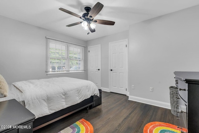 bedroom with dark hardwood / wood-style floors and ceiling fan