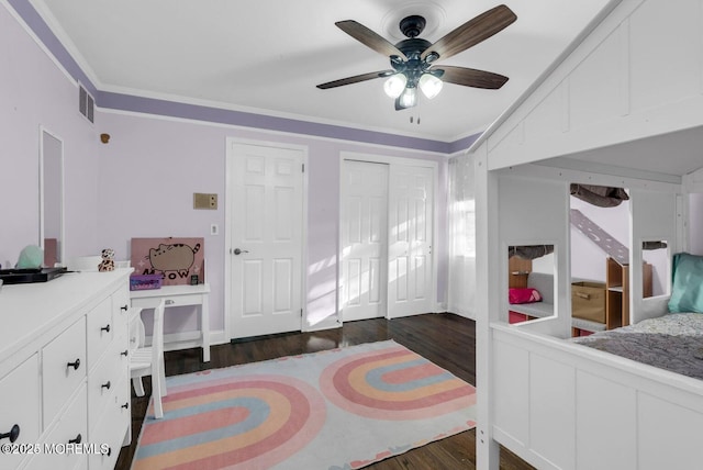 bedroom featuring lofted ceiling, crown molding, dark wood-type flooring, and ceiling fan