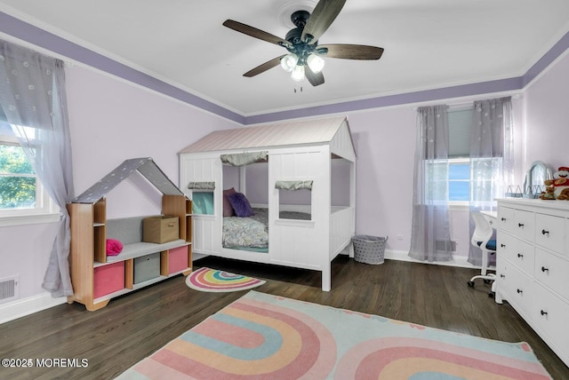 bedroom with dark hardwood / wood-style flooring, crown molding, and ceiling fan