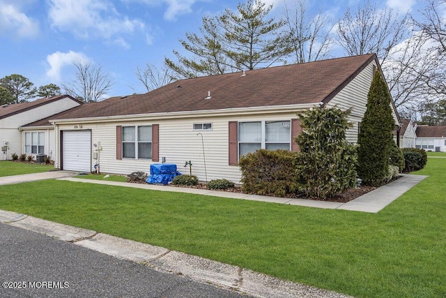 ranch-style house with a garage and a front yard