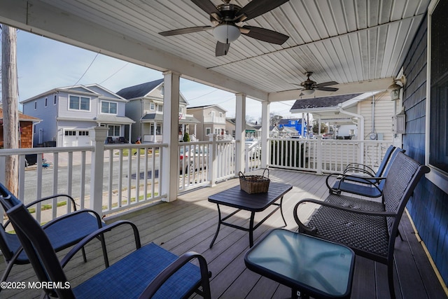 wooden terrace featuring a porch and ceiling fan