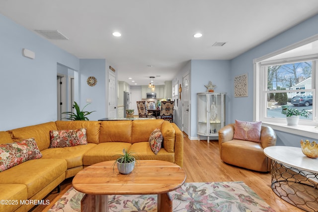 living room with light hardwood / wood-style flooring