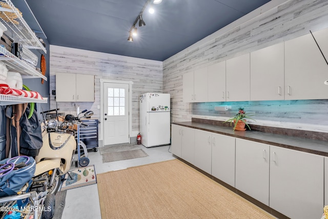 clothes washing area with track lighting