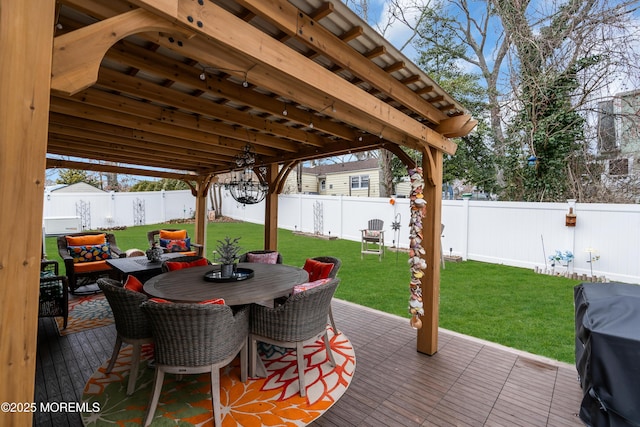 deck featuring grilling area and a lawn