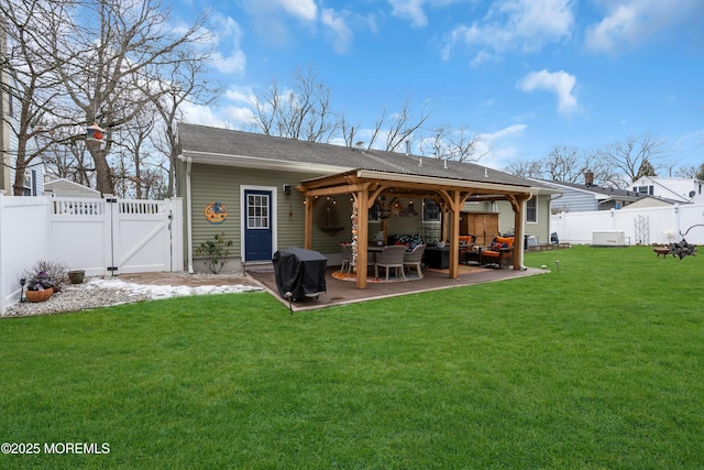 rear view of property with a yard, an outdoor hangout area, and a patio