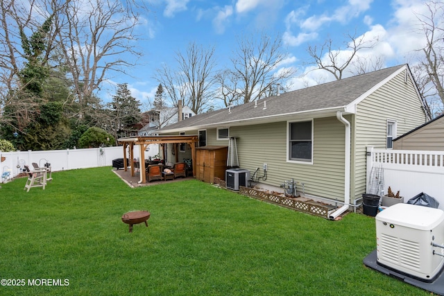 back of house featuring a lawn and central AC