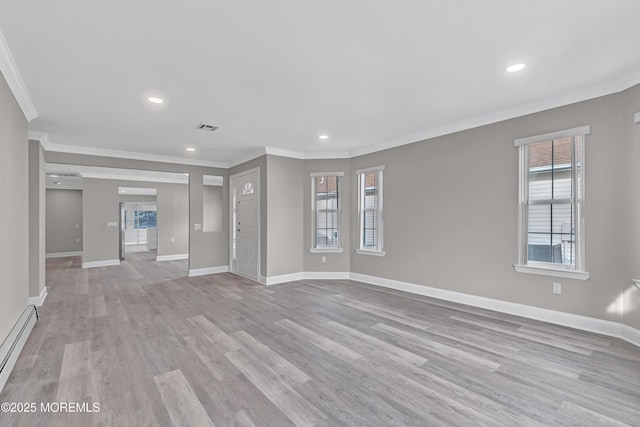 unfurnished living room featuring baseboard heating, plenty of natural light, and light hardwood / wood-style flooring