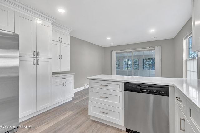 kitchen featuring white cabinetry, light hardwood / wood-style flooring, and appliances with stainless steel finishes