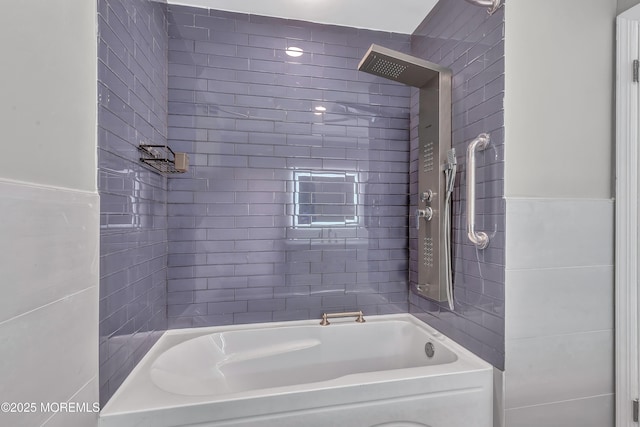 bathroom featuring tile walls and tiled shower / bath