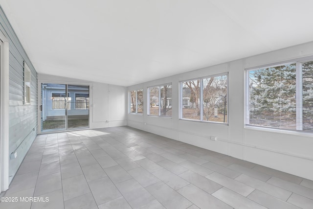 unfurnished sunroom with vaulted ceiling