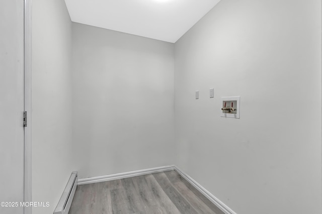 washroom with washer hookup, light wood-type flooring, and a baseboard heating unit