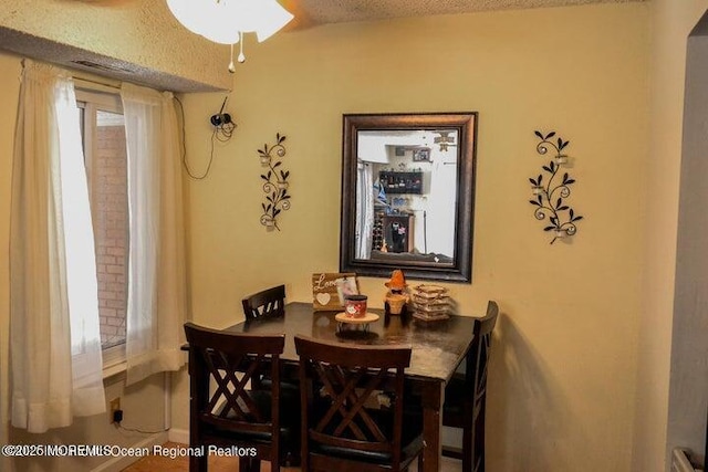 dining area with a textured ceiling