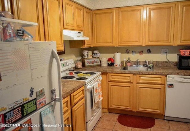 kitchen with white appliances, sink, and light tile patterned floors