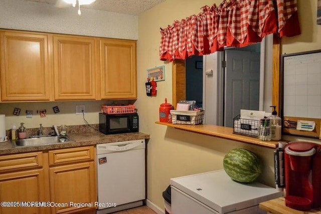 kitchen with sink, white dishwasher, and a textured ceiling