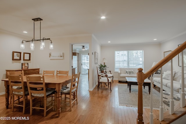 dining area with ornamental molding, ceiling fan, and light hardwood / wood-style flooring