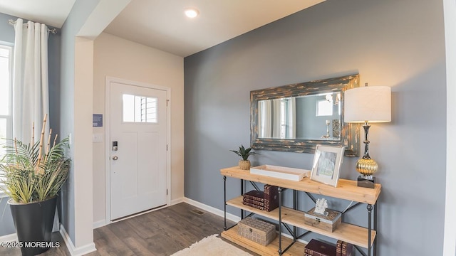 entrance foyer with baseboards and wood finished floors