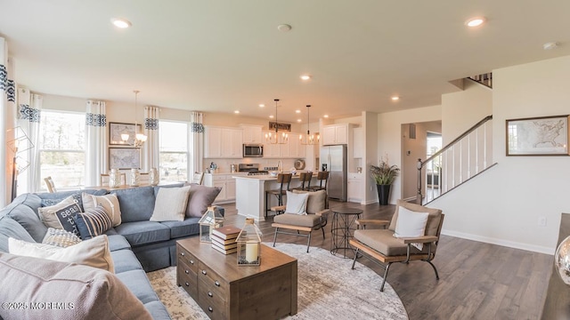 living room featuring hardwood / wood-style flooring and a notable chandelier