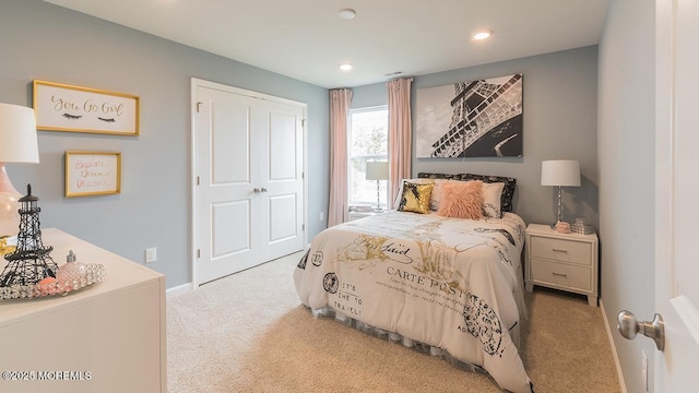 bedroom featuring light carpet and a closet