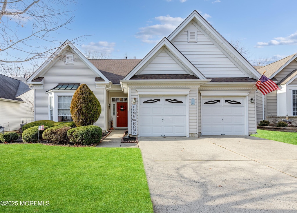 view of front of house with a front yard and a garage