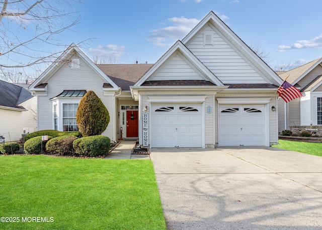 view of front of house with a front yard and a garage