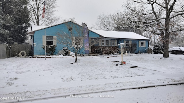 view of snow covered rear of property