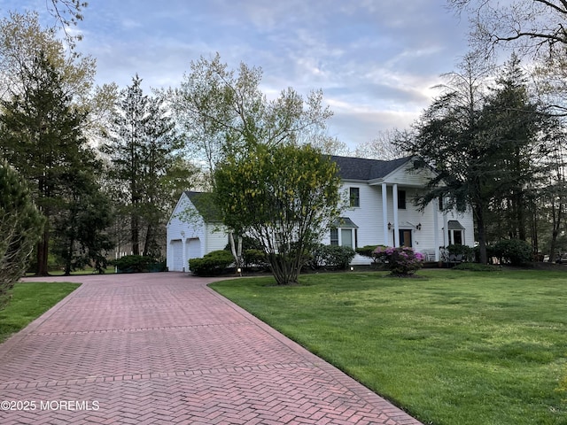 view of front of home with a front yard and a garage