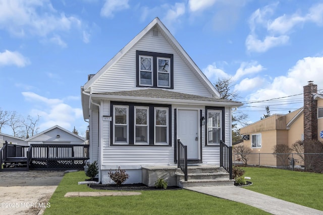 bungalow-style house with a wooden deck and a front yard