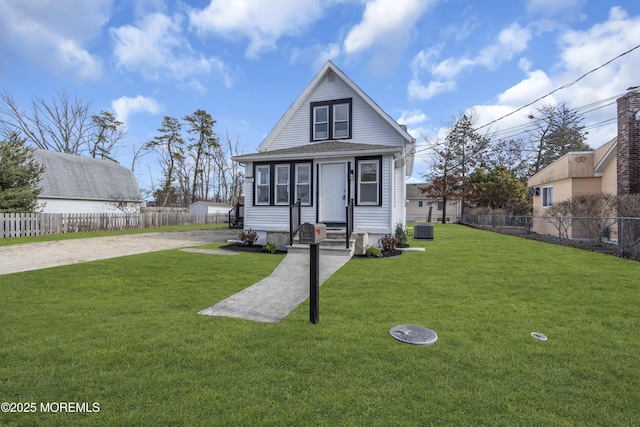 view of front of house featuring a front yard and cooling unit