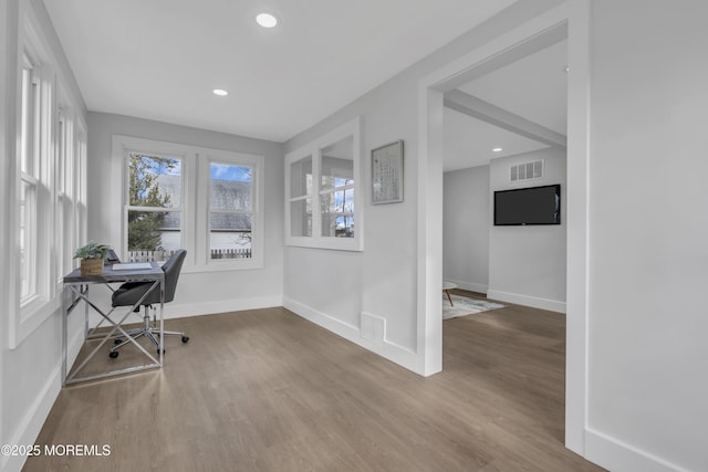 unfurnished office featuring hardwood / wood-style floors