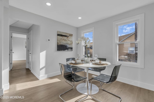 dining space with light wood-type flooring