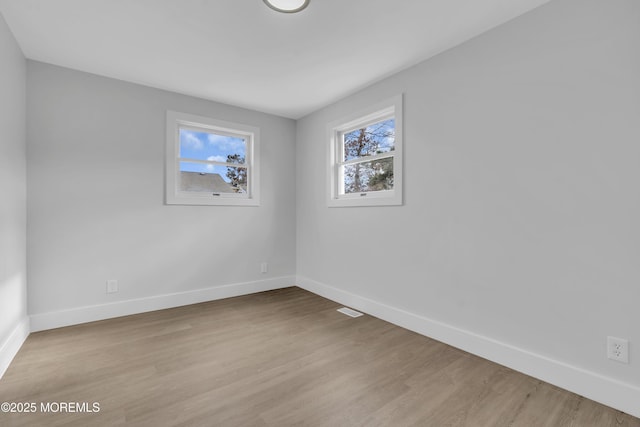 spare room featuring light wood-type flooring