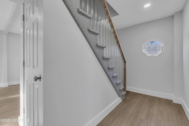 stairway with hardwood / wood-style flooring