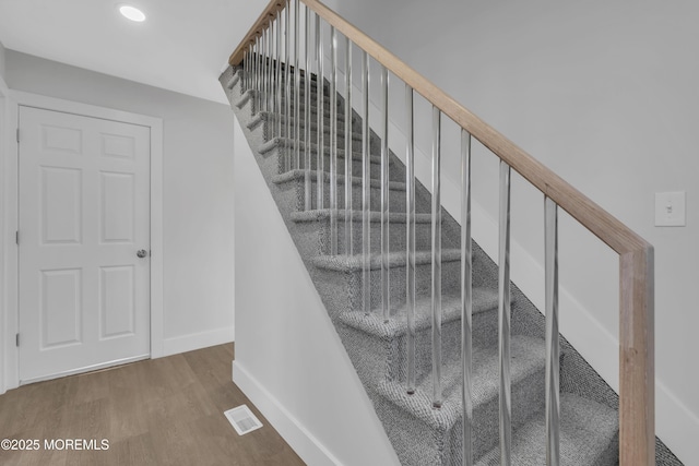 stairway with hardwood / wood-style floors