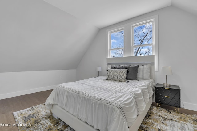 bedroom with dark hardwood / wood-style flooring and lofted ceiling